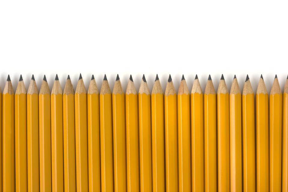 Row of Yellow Pencils Repetition for Education on White Background