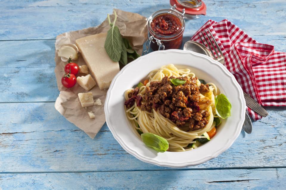 Plate of Spaghetti Bolgnese and ingredients