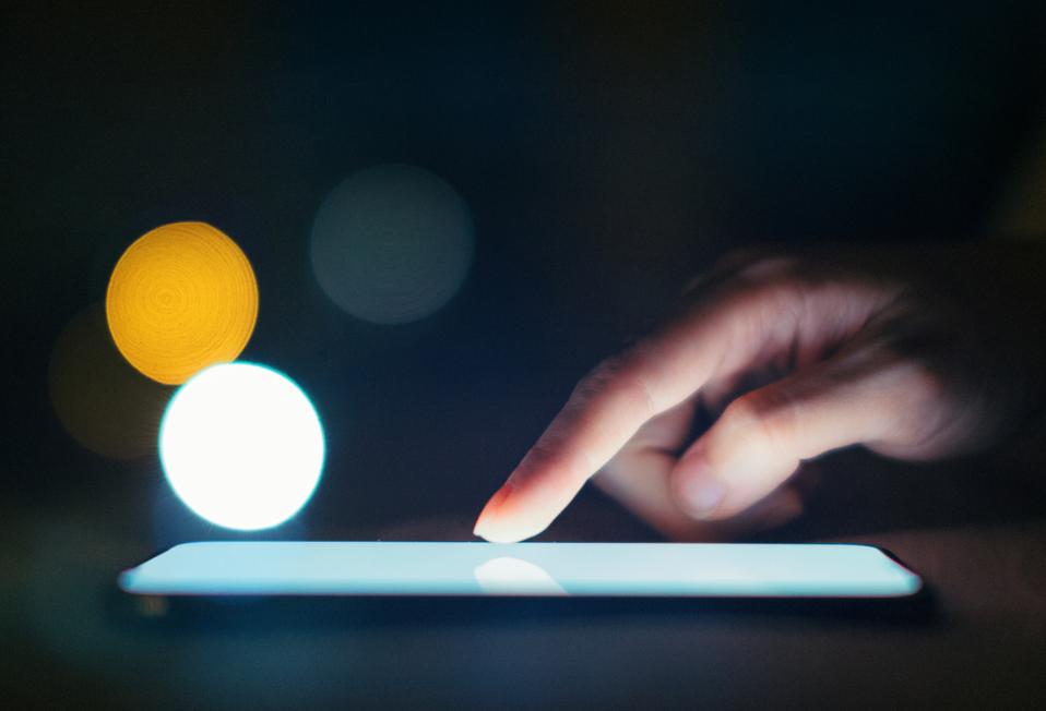 Female Hands Using Smart Phone In The Dark At Night