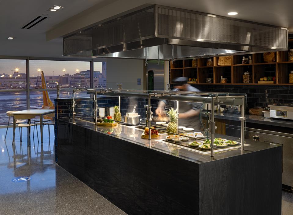 a chef cooks at the Centurion AMEX lounge in the Denver airport