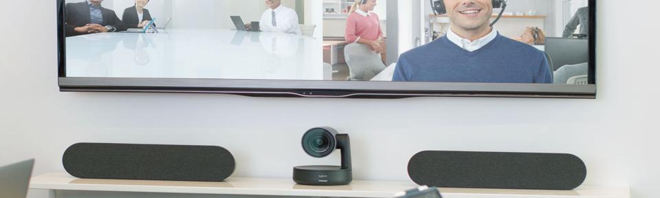 Logitech Rally Camera and speakers underneath a large screen.