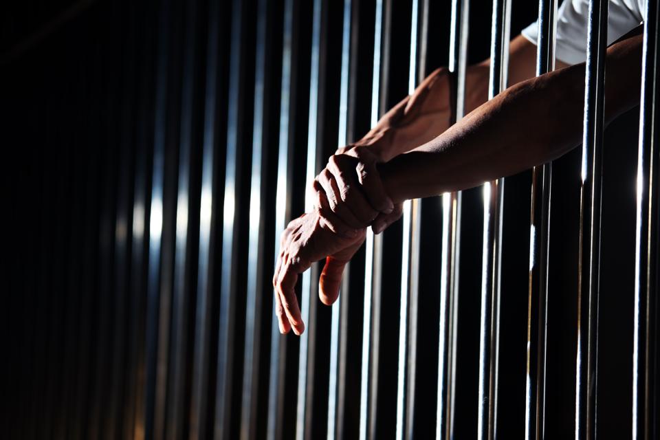 Close-up of hand in jail background