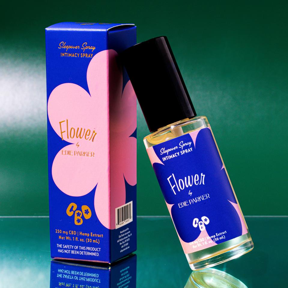 Flower by Edie Parker's new CBD Sleepover Spray against a green backdrop.