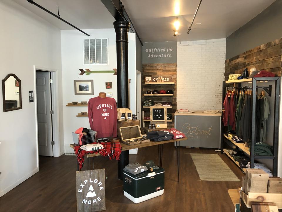 A retail space with shirts, sweaters, and other items available for sale.