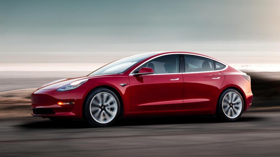 Red Tesla 3 on the road