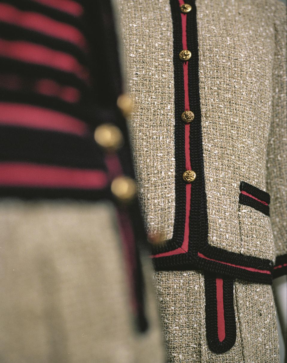 Close-up of two Chanel Spring-Summer 1961 suits in ficelle tweed, red grosgrain with navy blue braid, gilt metal. Paris, Chanel Heritage