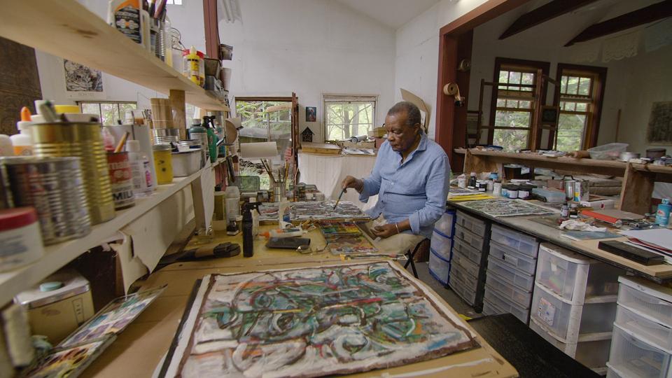 Artist, curator, educator, historian David Driskell painting in his studio.