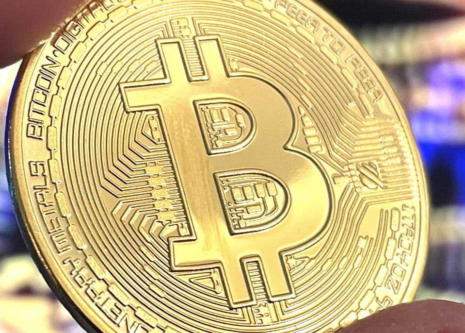 A physical unit of bitcoin, a digital currency.