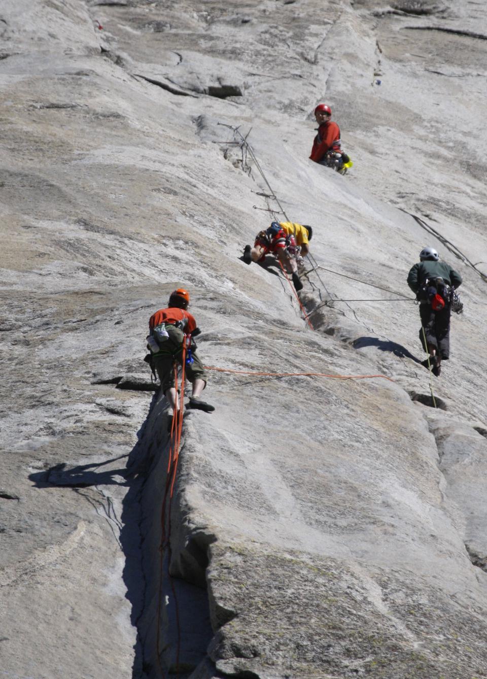 Climbers got out of the way to allow Hans Florine, bottom left, and Yuji Hirayama, 2nd from left in yellow, break their own speed record climb up the Nose of the internationally famous granite cliff known as El Capitan in Yosemite National Park on Sunday,