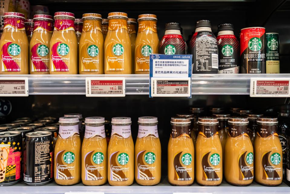 Bottles of Starbucks drinks in a display case.