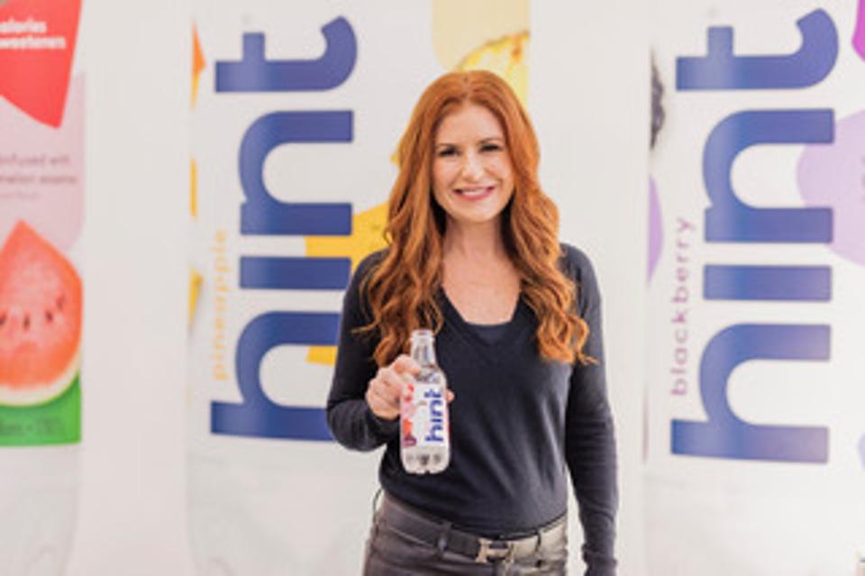 Kara Goldin holds a bottle of Hint Water.