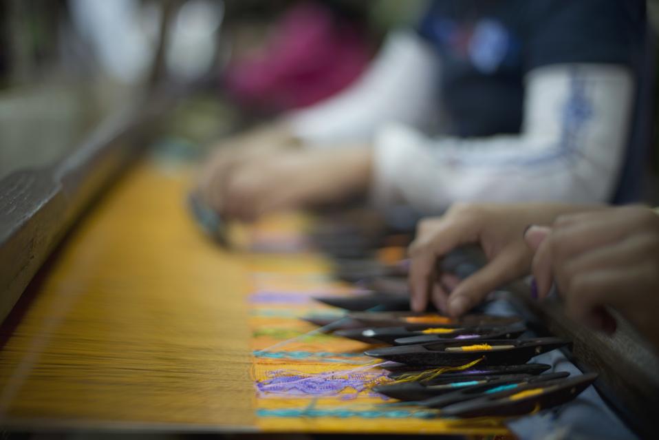 Workers weave silk at a factory in Mandalay, Myanmar.