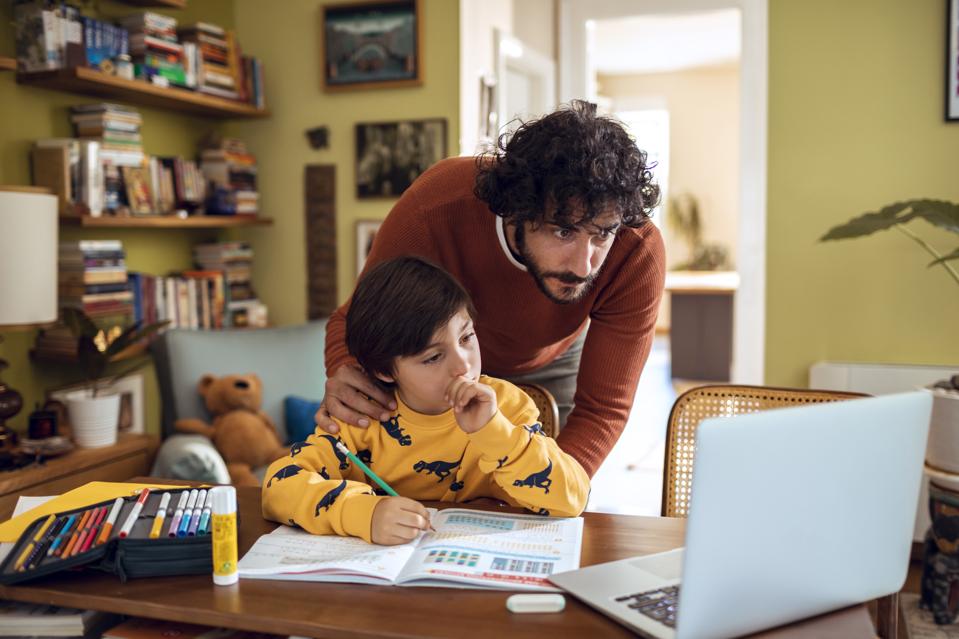 Father helping his son with schoolwork