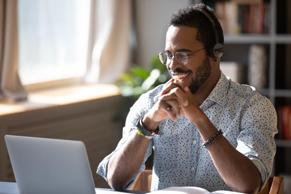 Smiling businessman holding video call with clients partners.