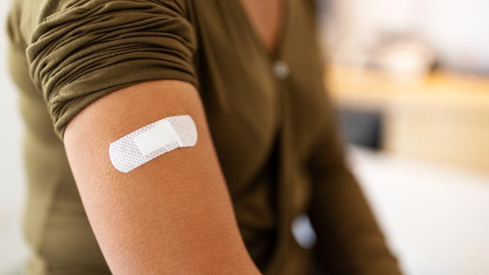Bandage on arm of a female after taking vaccine