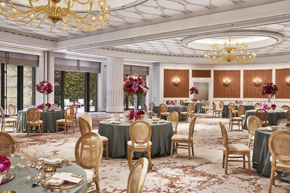 A ballroom at the Four Seasons hotel in Madrid is decorated for a wedding rehearsal dinner