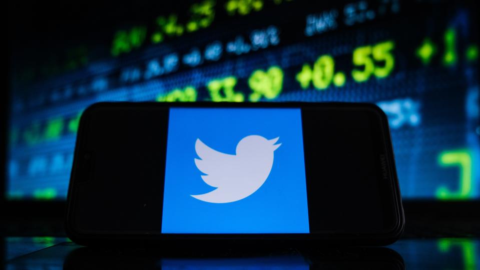 In this photo illustration a Twitter logo seen displayed on...