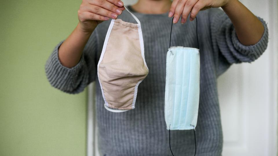 Disposable medical protective mask and reusable cotton protective mask flat lay.