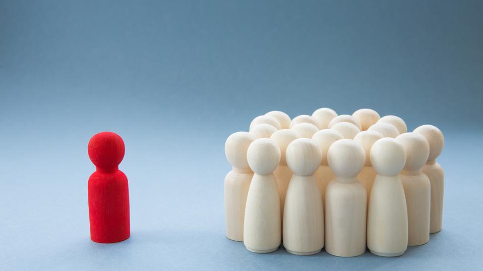 A Manager or Leader addressing a group of people or being isolated because of diversity