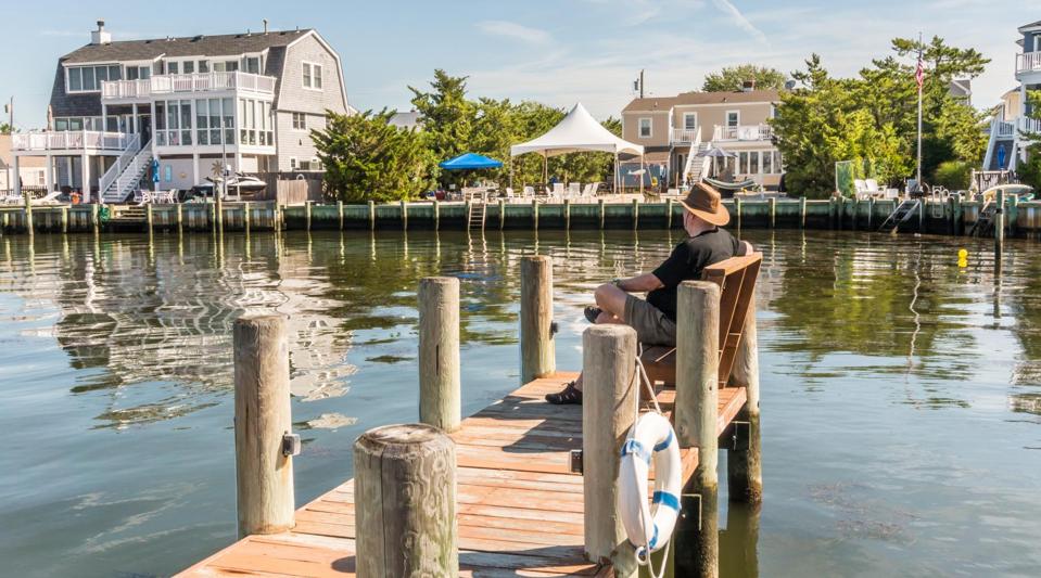 A man sitting on a dock during the summer in Nantucket.