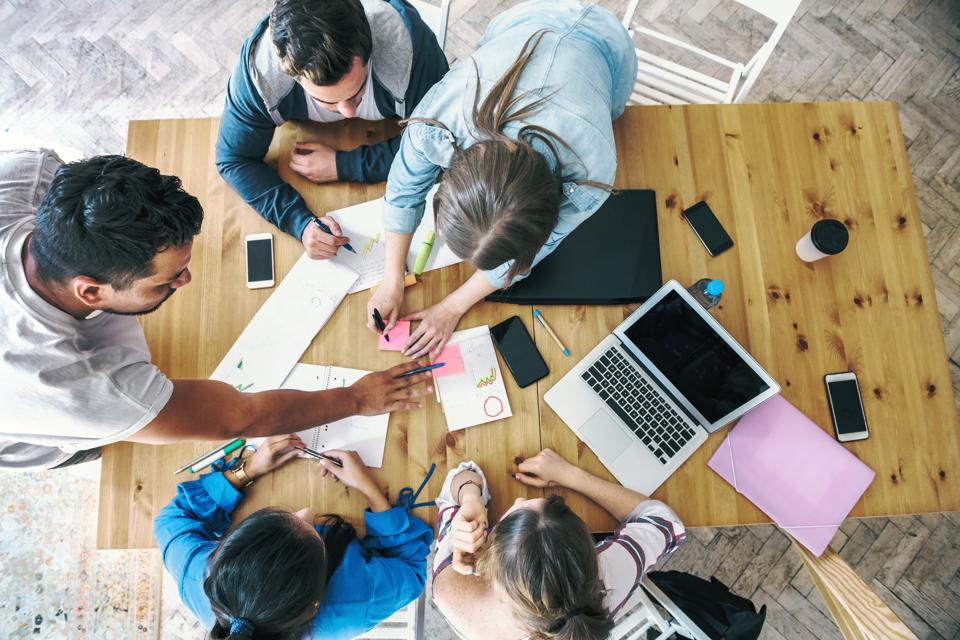overhead view on business people working together on desk