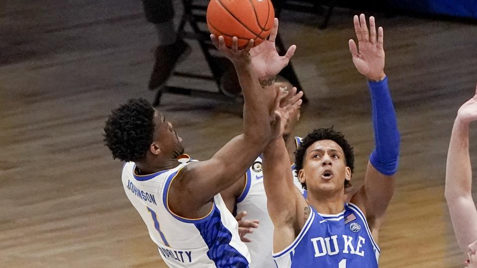 Pittsburgh's Xavier Johnson, left, shoots over Duke's Jalen Johnson.