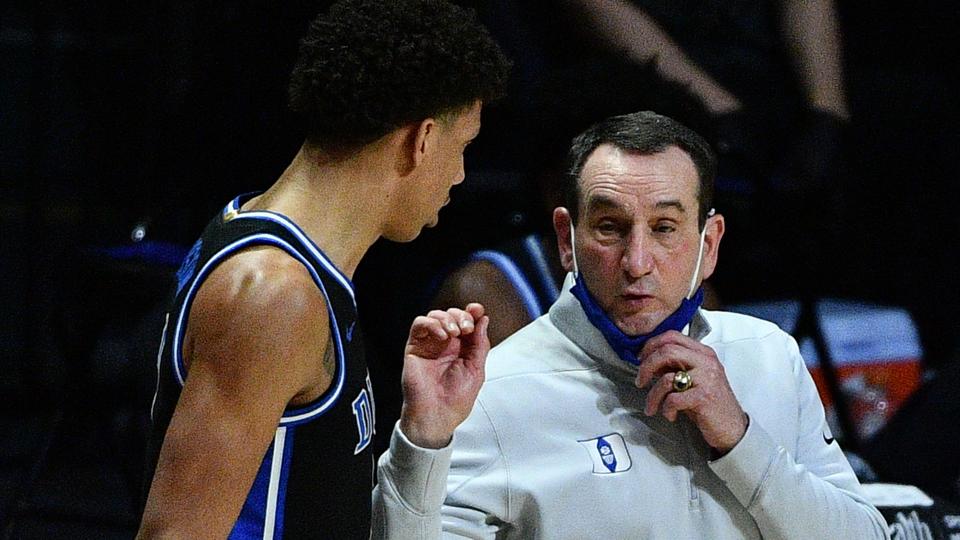 Head Coach Mike Krzyzewski of the Duke Blue Devils speaks with Jalen Johnson.