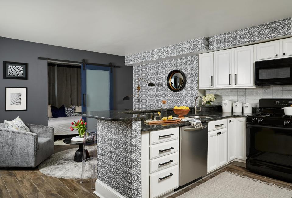 A beautiful kitchen and living space with vibrant wallpaper.