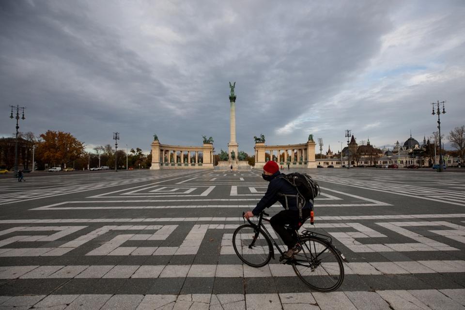 A cyclist crosses Heroes square in Budapest, Hungary.
