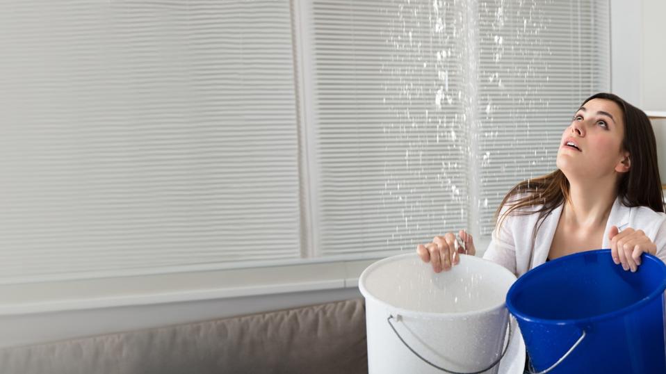 Woman Holding The Buckets Under The Water Leakage