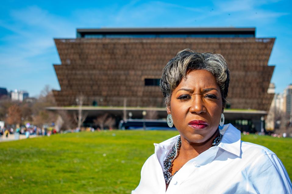 Cannabis activist Khadijah Tribble poses in front of Washing, D.C.'s African American Museum.