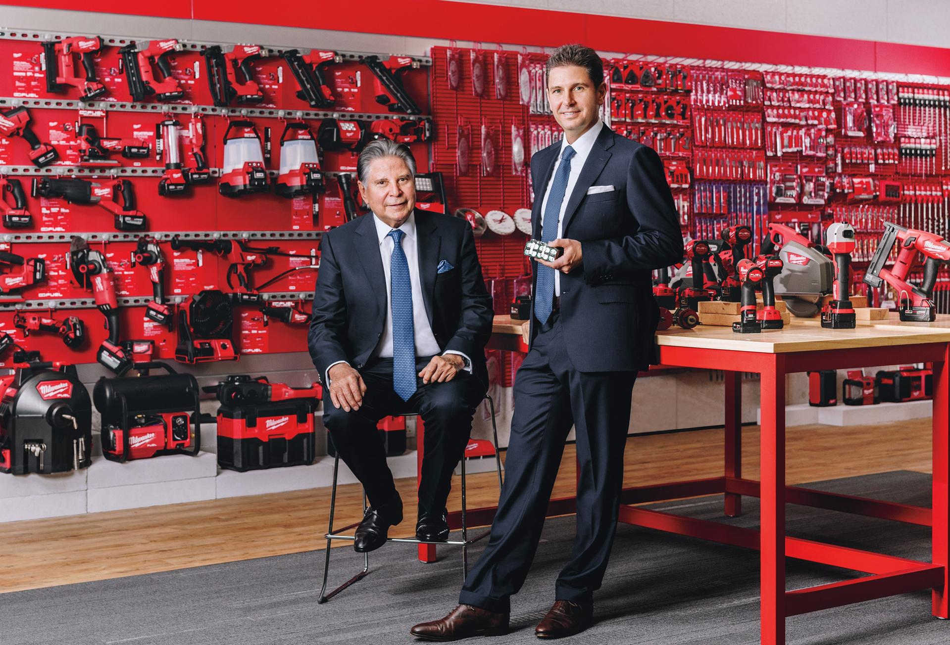 Horst with Stephan (right), who is holding a set of lithium-ion batteries. Its Milwaukee brand—on display in a company showroom—pioneered the use of lithium-ion batteries to power cordless tools.
