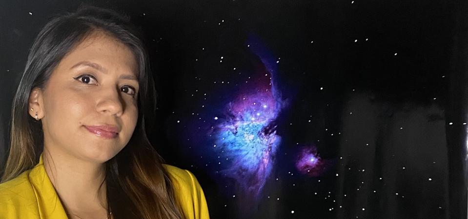 Colombian researcher Lauren Flor-Torres in front of an image of the M42 (The Orion Nebula) taken with Celestron EdgeHD 8″ SCT Telescope (property of Astronomy’s department at University of Guanajuato) by Faiber Rosas in February 2020.