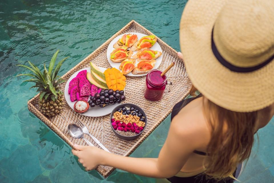 Breakfast tray in swimming pool, floating breakfast in luxury hotel.