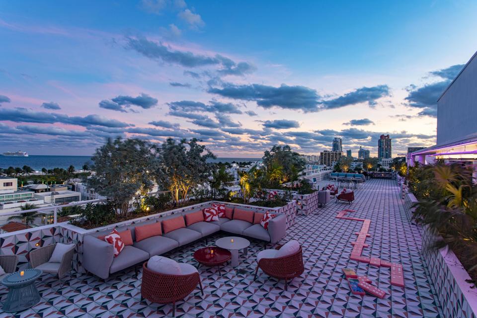 The hotel's sprawling rooftop bar is comprised of multiple seating areas and offers panoramic views of Miami Beach.