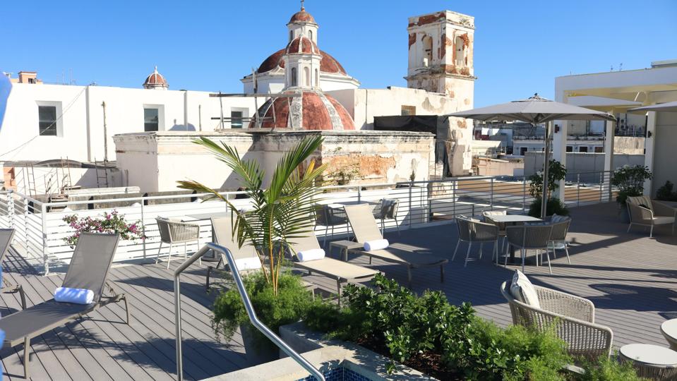 A rooftop deck with a pool