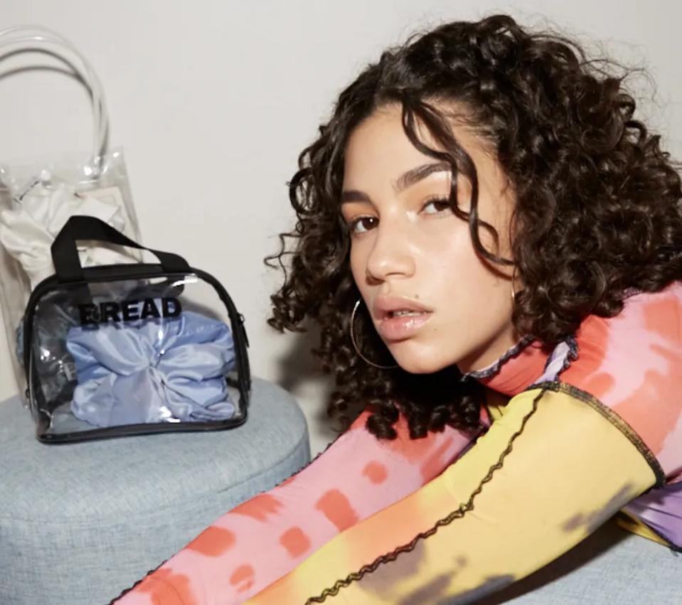 Model with curly hair posing for Bread Beauty Supply.