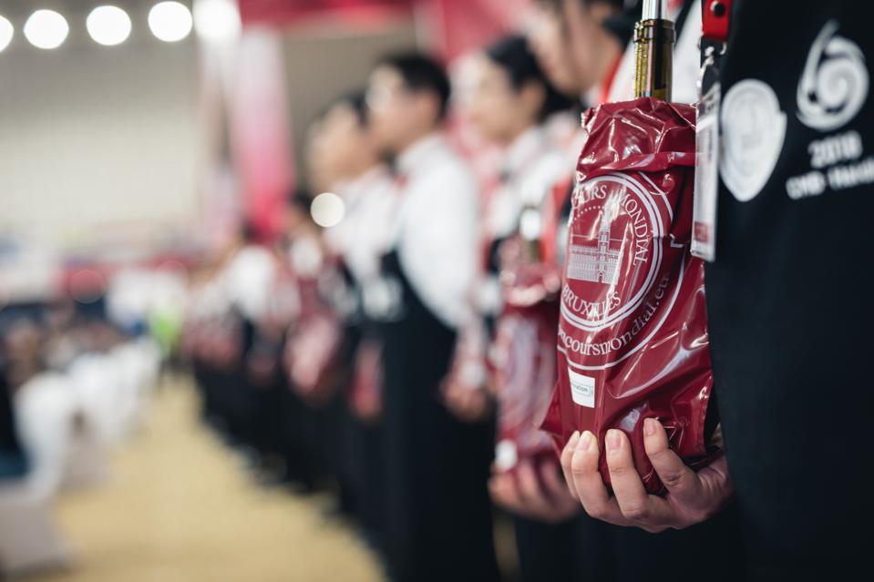 Sommeliers lined up to pour wine for Concours Mondial de Bruxelles tasters.