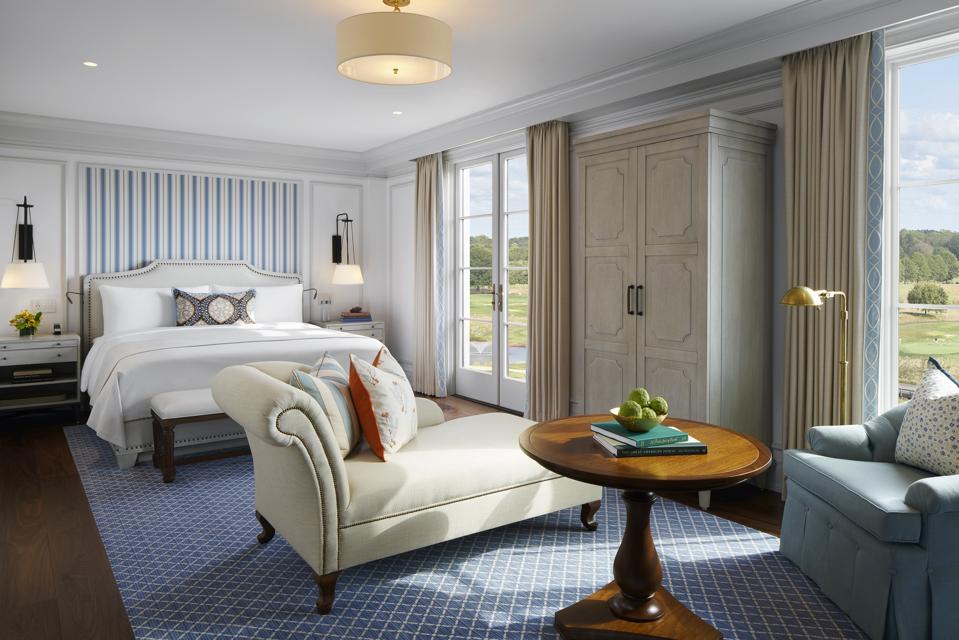 A blue, contemporary hotel bedroom