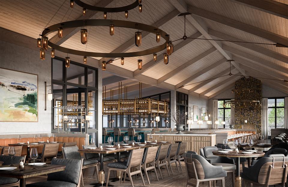 An open plan brown and grey restaurant with large chandelier