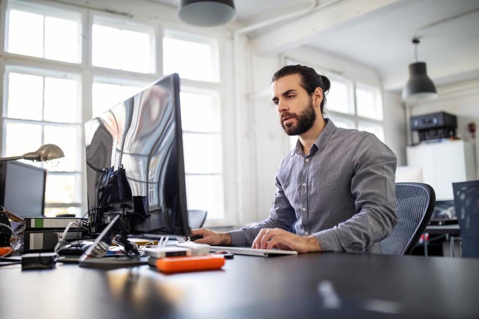 Computer programmer working at his desk