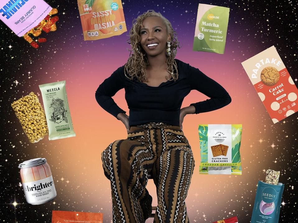 Tometi sits on a stool surrounded by snacks floating in space.