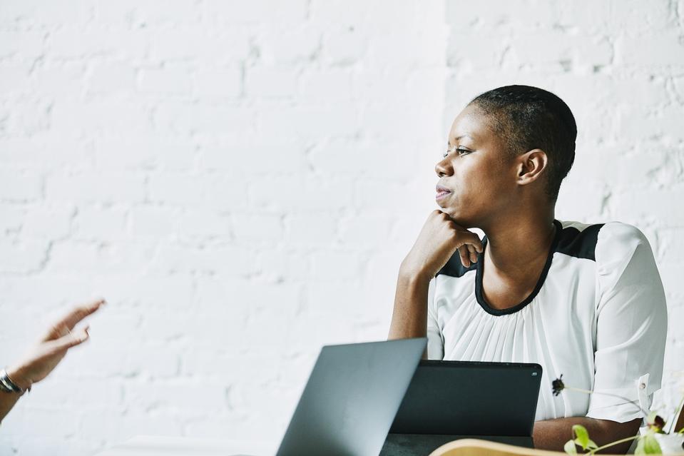 Businesswoman listening to client during meeting in office conference room