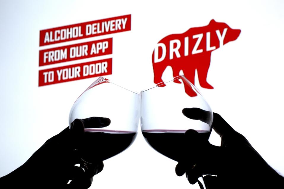 In this photo illustration silhouette of hands with wine...