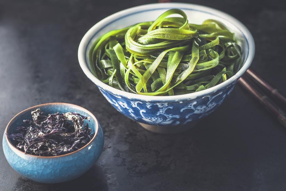 Various type seaweeds, nori and wakame seaweed on the black background, sea vegetables. Healthy Snack, Korean or Japanese food