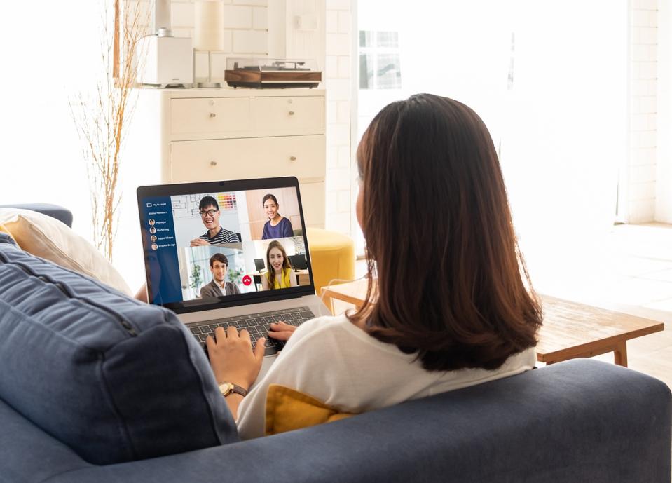 Young Asian businesswoman work at home and virtual video conference meeting with colleagues business people, online working, video call due to social distancing at home office