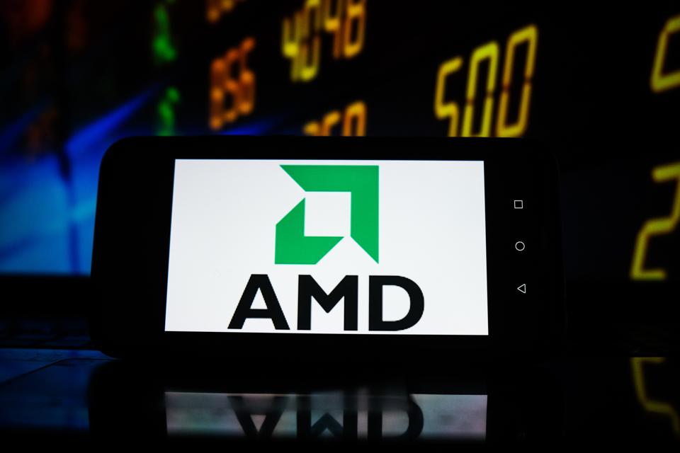 In this photo illustration an AMD logo seen displayed on a...