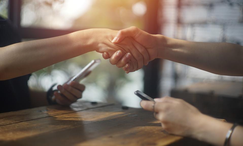 close up business female shaking hand for accept deal at cafe