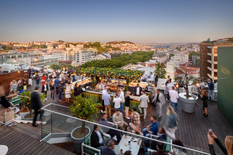 People are at the rooftop bar at Sky Bar by Seen at the Tivoli hotel in Lisbon, Portugal