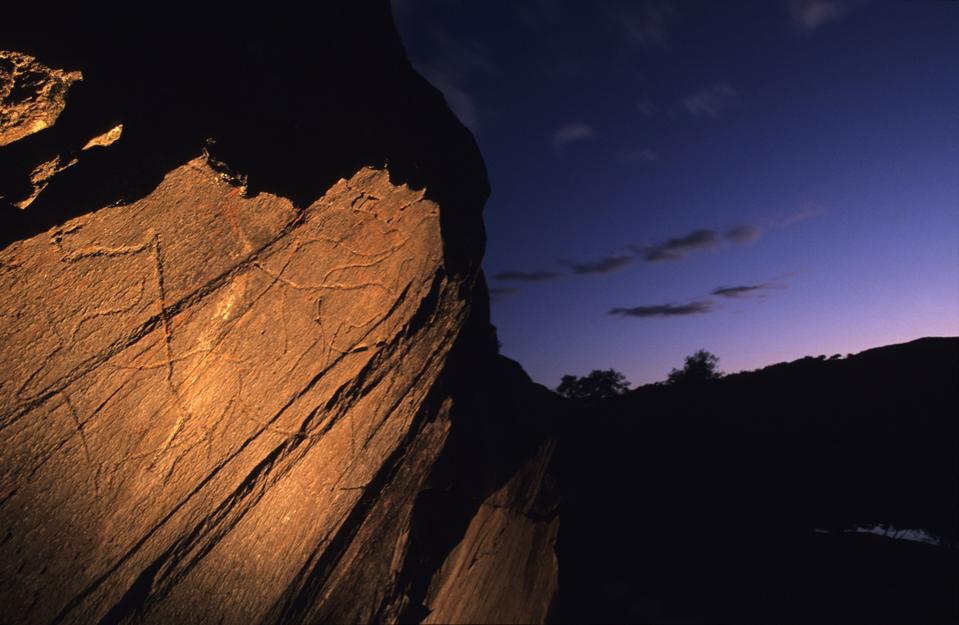 The prehistoric rock at in the Côa valley in Portugal is illuminated at dusk